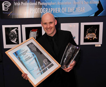Irish photographer David Cantwell receiving award for Photographer of the Year 2008 with a selection of the watch jewelry images in the background